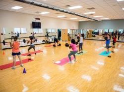 Group fitness class lifting weights