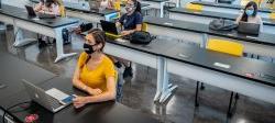 photo of female students in classroom socially distanced wearing facemasks