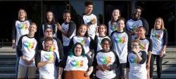 The staff of the LGBTQ Center standing on the steps of the Student Center.