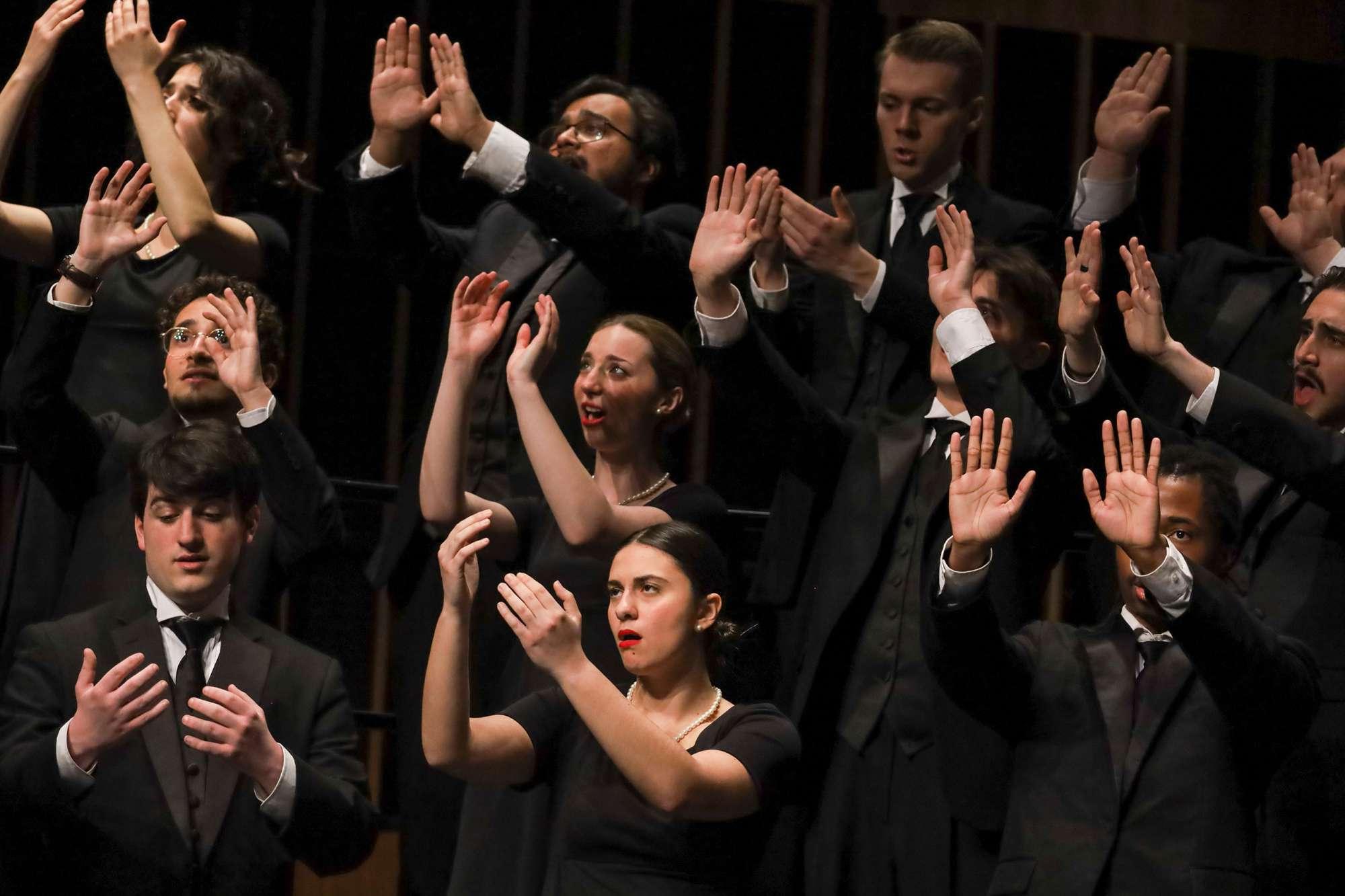 Singers make hand gestures during a song