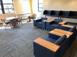 Another common area in Sinatra Hall featuring some chairs and some tables.