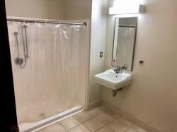 A shower and sink in a bathroom in Sinatra Hall.